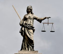 A statue of lady justice holding a sword and a scale