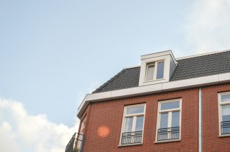 brown and white concrete building under white sky during daytime