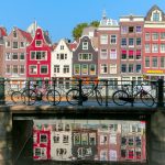 black bicycle leaning on black metal fence